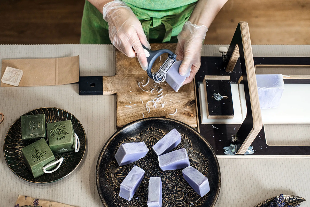 Handcrafted soap being cut into pieces.